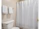 Bathroom with white shower curtain and tile floors at 13516 W Windsor Blvd, Litchfield Park, AZ 85340