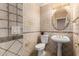 Charming powder room showcasing unique tilework, a pedestal sink, and decorative fixtures at 13516 W Windsor Blvd, Litchfield Park, AZ 85340