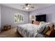 Light bedroom with a ceiling fan and large window at 13516 W Windsor Blvd, Litchfield Park, AZ 85340