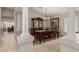 Elegant dining room with a large wooden table, hutch, and a stylish chandelier at 13516 W Windsor Blvd, Litchfield Park, AZ 85340