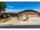 Charming single-story home with a well-manicured lawn, mature tree, and a spacious three-car garage at 13516 W Windsor Blvd, Litchfield Park, AZ 85340