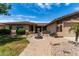Charming home featuring desert landscaping, a well-manicured lawn, mature bushes and trees, and a water fountain at 13516 W Windsor Blvd, Litchfield Park, AZ 85340