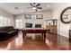 Spacious game room with hardwood floors, a pool table, and a cozy fireplace at 13516 W Windsor Blvd, Litchfield Park, AZ 85340