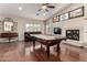 Bright game room featuring a pool table, fireplace, and comfortable seating area at 13516 W Windsor Blvd, Litchfield Park, AZ 85340