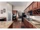 Well-equipped kitchen featuring wood cabinetry, granite countertops and stainless steel appliances at 13516 W Windsor Blvd, Litchfield Park, AZ 85340
