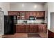 Functional kitchen with stainless appliances, ample cabinet space, and granite countertops at 13516 W Windsor Blvd, Litchfield Park, AZ 85340