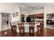Open concept kitchen with granite countertops, dark wood cabinets, and a breakfast bar at 13516 W Windsor Blvd, Litchfield Park, AZ 85340