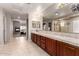 Luxurious bathroom with dual sinks, tile flooring, and a separate shower at 13516 W Windsor Blvd, Litchfield Park, AZ 85340