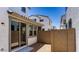 Small backyard with beige brick walls, stucco exterior, and sliding glass doors at 14636 W Sand Hills Rd, Surprise, AZ 85387