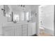 This is a modern bathroom with double sinks, drawers, and a bathtub at 14636 W Sand Hills Rd, Surprise, AZ 85387