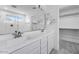 Modern bathroom features a double sink vanity and an attached shower and walk-in closet at 14636 W Sand Hills Rd, Surprise, AZ 85387