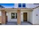 Home entrance showcasing brick columns, a covered porch, a dark-colored door, and a sidelight window at 14636 W Sand Hills Rd, Surprise, AZ 85387