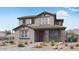 Charming two-story home featuring stone accents, a red front door, and desert landscaping at 14636 W Sand Hills Rd, Surprise, AZ 85387