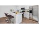 Close-up view of a modern kitchen with stainless steel appliances and white countertops at 14636 W Sand Hills Rd, Surprise, AZ 85387
