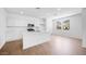 Bright, modern kitchen featuring white cabinets, stainless steel appliances, tiled floors and a center island at 14636 W Sand Hills Rd, Surprise, AZ 85387