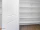 Walk-in pantry with multiple shelves and tiled floors, ready for all your storage needs at 14636 W Sand Hills Rd, Surprise, AZ 85387