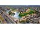 An aerial view shows a beautiful golf course, community lakes, and desert landscaping at 15900 W Autumn Cir, Surprise, AZ 85374