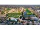 Aerial view of the golf course community with water features and a parking lot at 15900 W Autumn Cir, Surprise, AZ 85374