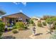 Backyard with desert landscaping, mature trees, a hammock, and outdoor seating area at 15900 W Autumn Cir, Surprise, AZ 85374