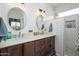 Beautiful bathroom featuring a double sink vanity, tile backsplash, and modern lighting fixtures at 15900 W Autumn Cir, Surprise, AZ 85374