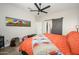 Bright bedroom featuring a ceiling fan, wood floors, and natural light with a sliding barn door at 15900 W Autumn Cir, Surprise, AZ 85374