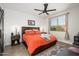 Comfortable bedroom with wood-look flooring, shiplap accent wall, a ceiling fan, and ample natural light at 15900 W Autumn Cir, Surprise, AZ 85374