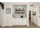 Stylish built-in storage with open shelving, sleek white cabinets, and modern decor accents at 15900 W Autumn Cir, Surprise, AZ 85374