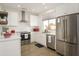 Updated kitchen featuring stainless steel appliances, white cabinets, subway tile, and modern finishes at 15900 W Autumn Cir, Surprise, AZ 85374