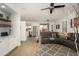 Spacious living room with a gray sectional sofa, modern decor, and an open layout at 15900 W Autumn Cir, Surprise, AZ 85374