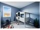 Cozy bedroom with a unique bunk bed, calming blue walls and natural light from the window at 16743 W Alameda Rd, Surprise, AZ 85387