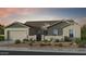 Charming single-story home with stone accents, neutral paint, desert landscaping, and an attached two-car garage at 18868 E Celtic Manor Dr, Queen Creek, AZ 85142