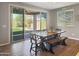 Dining room with hardwood floors, table seating for six, and sliding glass doors to the backyard at 18902 W Clinton St, Surprise, AZ 85388