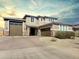 Handsome two-story home featuring a three-car garage, a well-kept lawn, and desert landscaping at 18902 W Clinton St, Surprise, AZ 85388