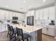 Kitchen featuring white cabinets, island with bar seating, stainless appliances, and subway tile backsplash at 18902 W Clinton St, Surprise, AZ 85388