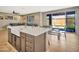 Open kitchen and dining area with a center island, sink, and views of the backyard at 18902 W Clinton St, Surprise, AZ 85388