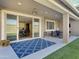 Inviting covered patio with ceiling fan, comfortable seating, and a view into the kitchen at 18902 W Clinton St, Surprise, AZ 85388