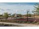 Outdoor basketball court featuring picnic tables with shade umbrellas, and lush green grass at 1978 W Lariat Ln, Phoenix, AZ 85085