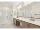 Sleek bathroom featuring a double vanity, large mirror, and glass-enclosed shower for modern living at 1978 W Lariat Ln, Phoenix, AZ 85085