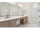 Stylish bathroom with double vanity, large mirror, and doorway leading to another room at 1978 W Lariat Ln, Phoenix, AZ 85085
