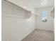 Bright walk-in closet with carpeted floor and ample shelving for storage at 1978 W Lariat Ln, Phoenix, AZ 85085