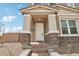 Inviting front entrance with decorative stone accents and a classic white door beneath a covered porch at 1978 W Lariat Ln, Phoenix, AZ 85085