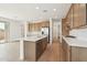 Bright kitchen with an island, stainless steel appliances, and wood flooring offers style and function at 1978 W Lariat Ln, Phoenix, AZ 85085