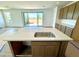 Kitchen island with a stainless steel sink, perfect for food preparation and entertaining at 1978 W Lariat Ln, Phoenix, AZ 85085