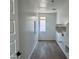 Well-lit laundry room featuring a window, built-in shelving, and hookups for appliances at 1978 W Lariat Ln, Phoenix, AZ 85085