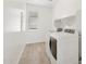 Efficient laundry room with tile floors, washer, dryer, storage shelves, and a window at 1978 W Lariat Ln, Phoenix, AZ 85085