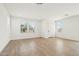 Bright, airy living room with light wood floors, white walls, and ample natural light from large windows at 1978 W Lariat Ln, Phoenix, AZ 85085