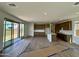 Spacious living room and kitchen area with access to the outdoor space through sliding glass doors at 1978 W Lariat Ln, Phoenix, AZ 85085