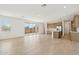 Spacious open-concept living area with light tile floors, a modern kitchen, and a seamless flow to the outdoors at 1978 W Lariat Ln, Phoenix, AZ 85085