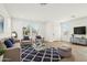 Comfortable living room featuring light wood floors, white walls, a plush rug, and stylish furnishings at 1978 W Lariat Ln, Phoenix, AZ 85085
