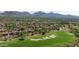 Aerial view of community homes and golf course featuring mountain views in the distance at 20750 N 87Th St # 2074, Scottsdale, AZ 85255